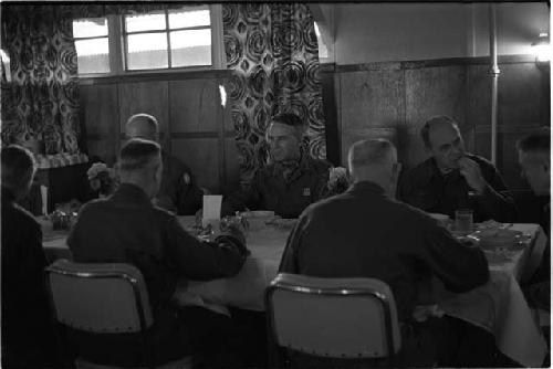 Military personnel sitting at a restaurant table