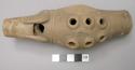 Unpainted ocarina with 6 vents.  No suspension holes.  Board incised lineal moti