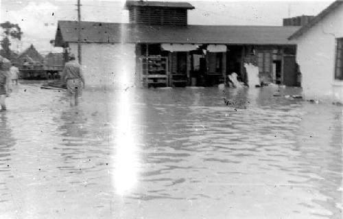 Men standing in flood