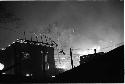 House at night with forest fire in background