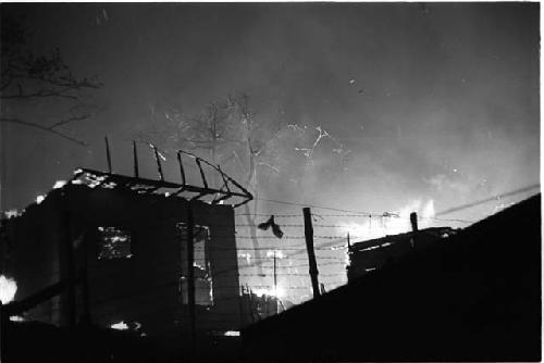 House at night with forest fire in background