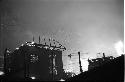 House at night with forest fire in background