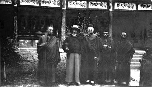 Several men and monks standing in courtyard