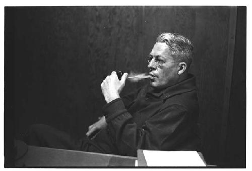 Man in American military uniform smoking pipe