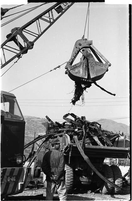 Crane lifting debris