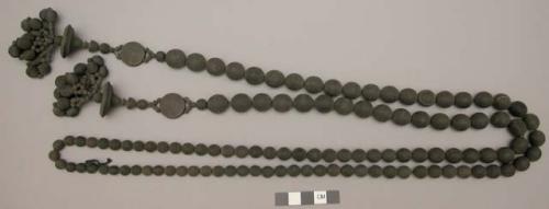 Long strand of round, grooved black wooden beads