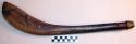 Club or paddle of dark brown wood with a flat curved blade