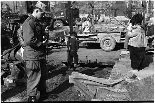 Two small children and a man holding a camera