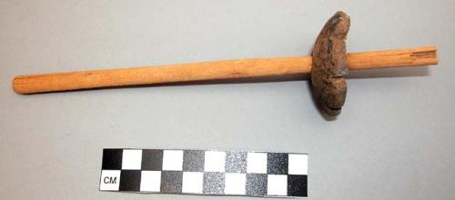 Spindle whorl. ceramic disk with wooden tube in center.