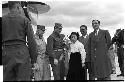 Military personnel standing beside plane