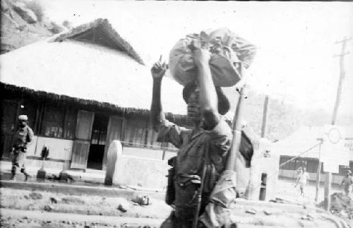 Man carrying bundle on his head