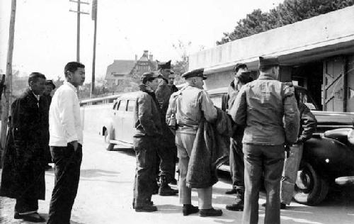 Men standing near cars