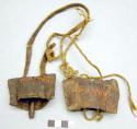 2 rectangular iron goat bells, with leather of fiber string for attachment. Mivi