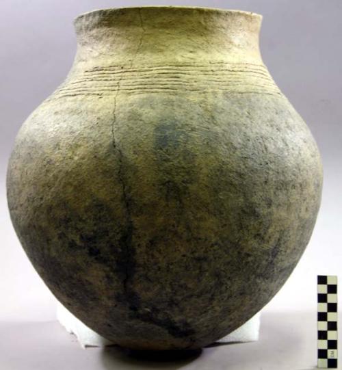 Ceramic jar, cord impressed shoulder, burnt, mended, sherds missing