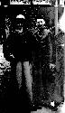 Three men standing in courtyard