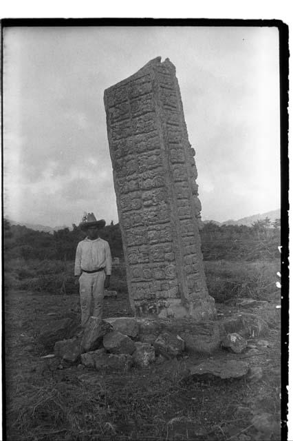 Man next to back of Stela A before straightening