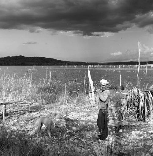 Man and dog in view of Yaxha from Topoxte