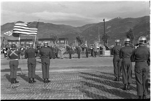 American flag being flown at parade