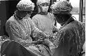 Three people performing surgery