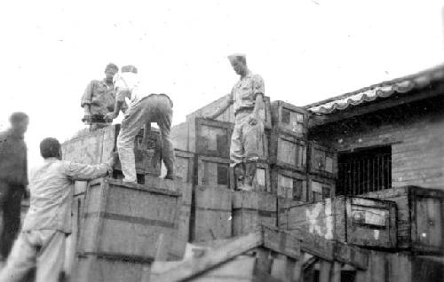 Soldiers moving crates