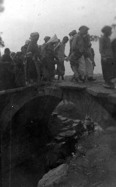 People walking over bridge