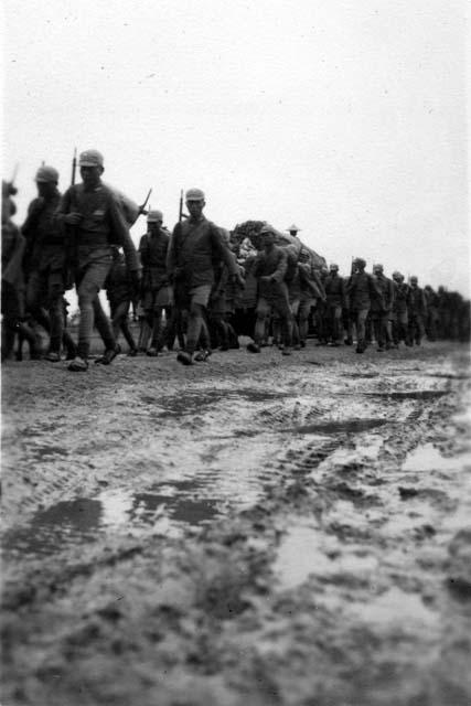 Soldiers marching in mud