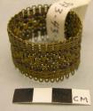 Woven brass ring, possibly a hair ornament
