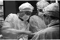 Three people performing surgery