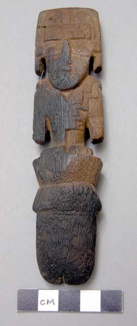 Carved wooden figurine standing on pole