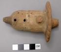 Ocarina with traces of white lines; fan or outspread tail motif; suspension hole