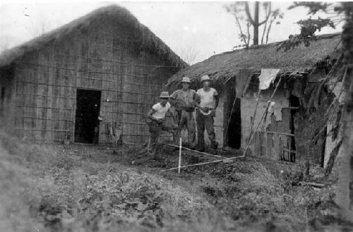 Men in front of huts