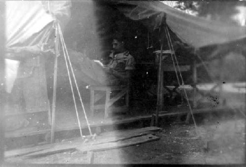 Man reading in tent