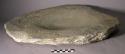 Metate. somewhat ovoid slab large shallow ovoid basin-like depression in center.