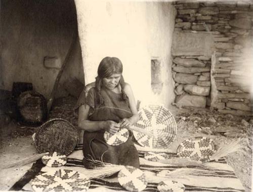 Hopi woman weaving plaques