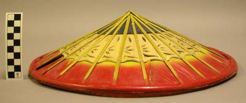 Wood hat painted in red, yellow and green