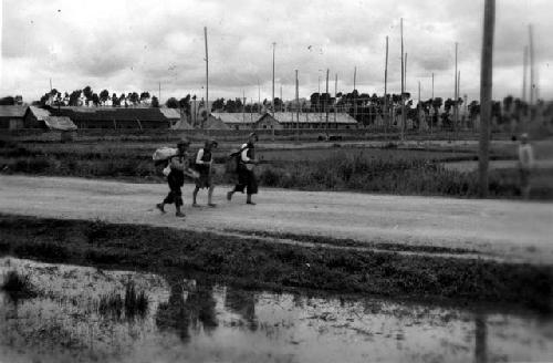 People walking along road