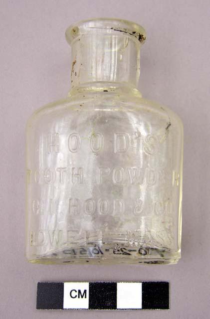 Clear glass tooth powder bottle, embossed
