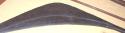 Long curved paddle of dark wood