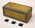 Small wooden box, sealed, unknown contents inside.