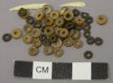 Beads, tortoise shell and nut beads, discoidal, with teeth fragments