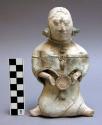 Seated female figure with pectoral