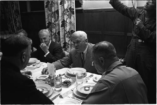 Men talking at a dinner table