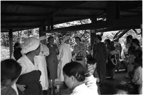 Gathering of women under a pavillion