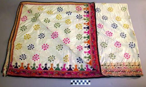 Cloth; cotton, heavily embroidered.