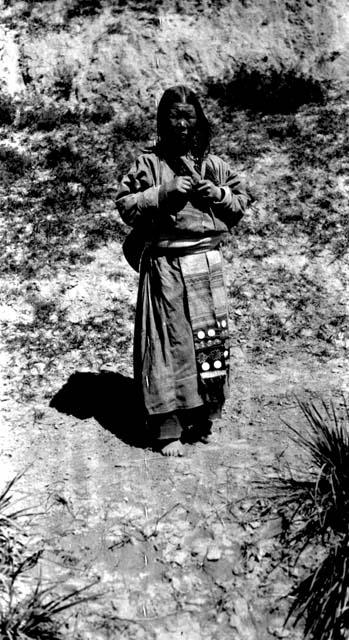 Barefoot Tibetan woman standing on road