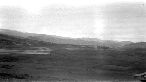 Landscape of grassland with mountains in background