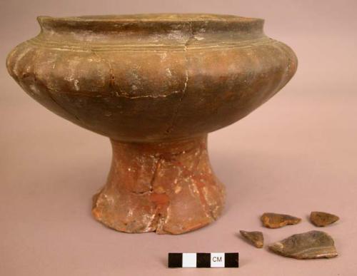 Restored pedestal pottery vessel and 4 sherds