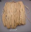 Man's "grass skirt," made from blanched fibers of unopened coconut +