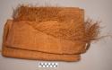 Large piece of grass cloth with long fringes on two ends