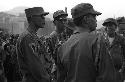 Military Men standing outside, 3 in foreground